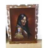 Embellished print of a native woman on canvas with a carved frame