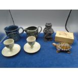 Holkham pottery snowdrop eggcups and 2 cups, a Wade tortoise in box and a black pottery toby jug