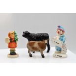 Goebel child carrying a Christmas tree; Beswick Clown; Galloway calf figurine and a figurine of a