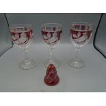 3 cranberry (coloured) stemmed glasses and a bell