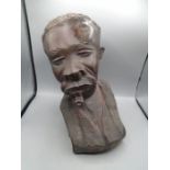 Lignum vitae bust of an African man with a pipe approx 16" tall