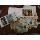 loose stamps, album of old postcards and a 'signed' christmas card from The Queen