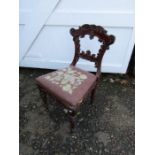 Ornate mahogany chair with upholstered seat