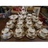 Royal Albert 'country roses' tea set comprising 12 cups, saucers and cake plates, a round cake