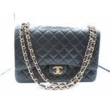Chanel XL maxi classic handbag - Black quilted Lambskin with gold tone metal size - 23 x 33 x 10cm