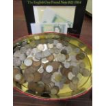 A tin of mixed coinage and 2 one pound notes