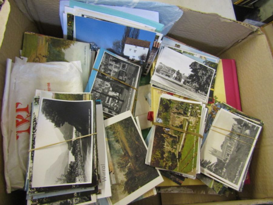 A box of loose vintage postcards including newspaper postcards of Diana plus an empty photo album