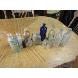 Glass bottles including East Dereham Codd bottle and stoneware pots including Norwich and Swaffham