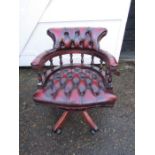 Ox blood red leather swivel Captains chair with one loose wheel