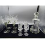 A decanter, 4 twisted stem glasses and 6 sherry glasses, all etched with a woodland scene and