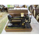 Vintage Singer sewing machine in wooden case with key