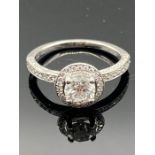A Platinum diamond halo cluster ring. The centre diamond weighs 0.82ct measuring 5.75mm. The