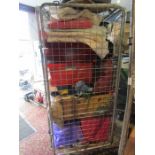 A stillage of clothing, handbags- incl Kippling, household linens, suitcases and storage boxes.