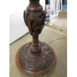 A heavy Oriental carved wooden lamp