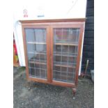 Oak glazed cabinet on legs with leaded glass H148cm W113cm D34cm approx one leg wobbly