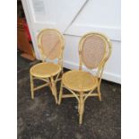 Pair of wicker chairs with cane seats