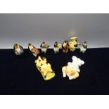 7 ceramic penguins playing instruments, a Colmans pig and another pig