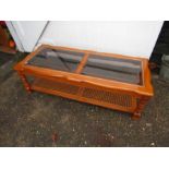Coffee table with glass top and cane shelf underne