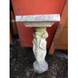 A concrete bird bath on a plinth depicting roman goddess' 31" tall