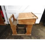 An vintage school desk with adjustable sliding desk