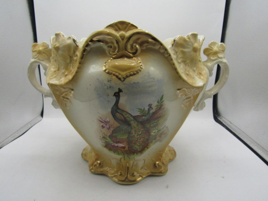 A vintage handled vase with peacock design 9.5" high and 10" across