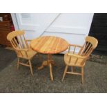 Round pedestal Pine table with 2 carver chairs. Table diameter 77cm approx