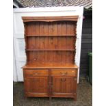 Pine dresser with 2 drawers and 2 door cupboard to base with shelving above H196cm W129cm D44cm