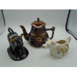Staffordshire black glazed cow creamer with gilt horns, a Crown Devon cow creamer with a Price