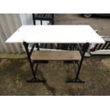 A marble top table on black metal trestle legs for potting bench/garden table
