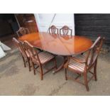 Extending veneered double pedestal dining table with 6 upholstered chairs
