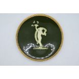 Minton Pate-sur-pate plate a green glaze panel with a cupid playing with butterflies and a gilt rim,