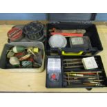 A tackle box and tin containing reels, old floats, flies etc