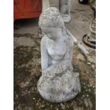 A concrete figure of a seated woman 21" tall