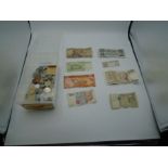 box of foreign bank notes and coins. including notes from Sri Lanka, Italian Lire, Kenyan