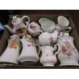 A collection of mini jugs, teapots