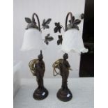 A pair of bronze coloured figuritive lamps with tulip shades