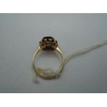 9ct gold ring with a ?single cushion cut garnet surrounded by 12 smaller stones, 2.68g gross