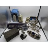 A silver plated egg cup/toast rack, boxed money boxes, looking glass, box, cruet set etc