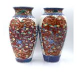 A pair of late 19th century Chinese famille rose vases of ovoid form with flared shaped rim 31cm