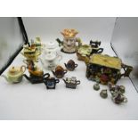 A collection of mini novelty teapots