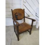 Arts and Crafts oak arm chair with leather seat and back both in need of re-upholstery