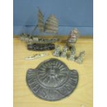 Metal sun plaque, led boat, fine brass boat, a stone carved man and 4 metal figures