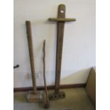 A pool cue holder, wooden mallett and knarly cane