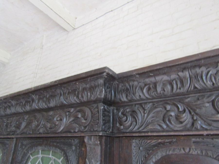 Carved oak Hunters cabinet with 2 central leaded glass doors above 2 door cupboard, flanked by - Image 9 of 9