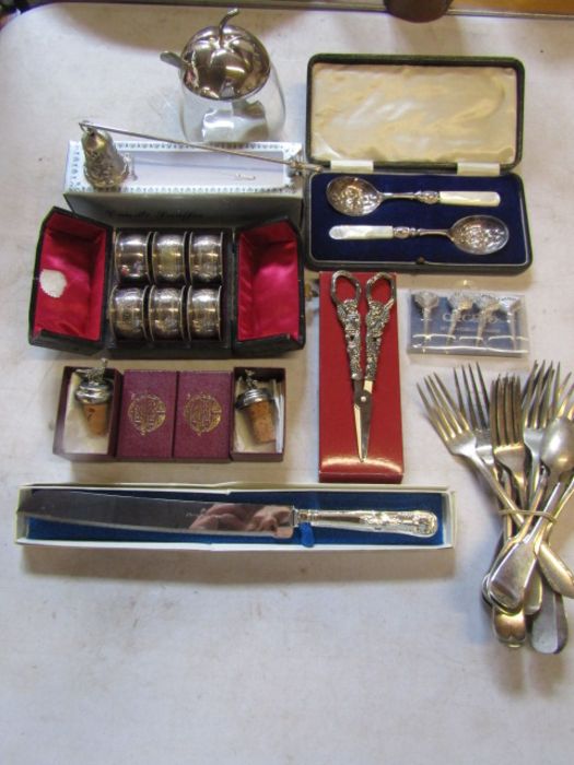 Collection of silver plate and other meta items to include napkin rings, cheese markers, candle