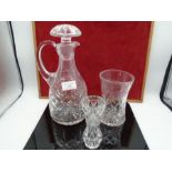 A cut glass decanter and two vases