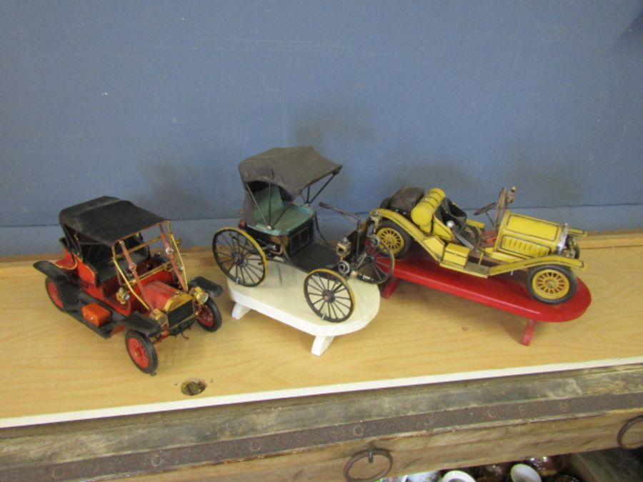 3 Vintage metal cars on stands. Tallest H30cm approx