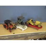 3 Vintage metal cars on stands. Tallest H30cm approx