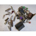 A collection of keys, bottleopeners, penknives