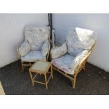 Pair of upholstered wicker conservatory chairs in need of re-upholstering with side table